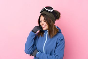 Young skier woman over isolated pink background laughing