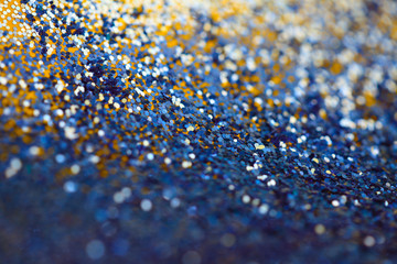 Gold and blue glitter shine dots confetti. Abstract light blur blink sparkle defocus backgound.