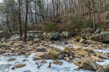 Frozen river with rocks and boulders