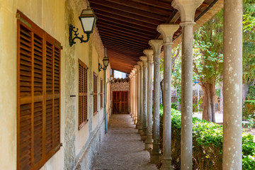 Street with columns near park in Valldemossa monastery, Mallorca, Spain