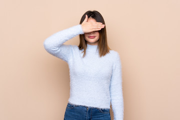 Young woman over isolated background covering eyes by hands. Do not want to see something