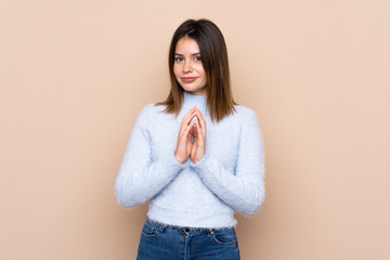 Young woman over isolated background scheming something