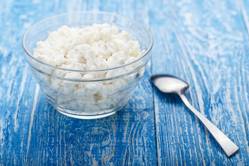 cottage cheese in a plate on a wooden background