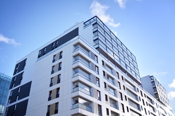 Fototapeta premium Fragment of modern residential apartment with flat buildings exterior. Detail of new luxury house and home complex. 