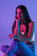 Young woman standing isolated on violet background