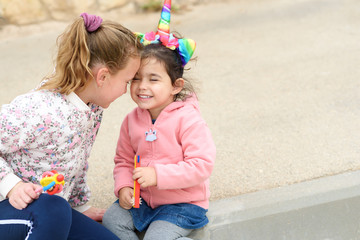 Funny little girs have fun outdoor. Toddler girl dressing up as a unicorn.