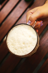 beer mug on the table in a female hand top view