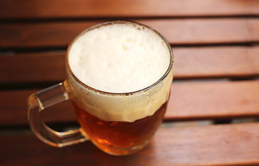 beer mug on a wooden table stands in a pub