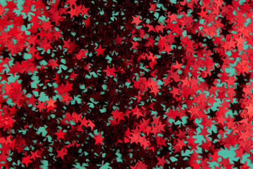 Red confetti in the shape of a star on a mint background. Christmas and New Year concept. Festive award or rating concept. Five stars.Trendy color 2020.