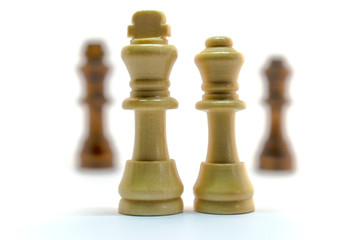conceptual photo of chess pieces on a white background