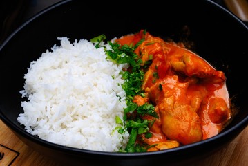 Chicken tikka masala served with white basmati rise and herbs