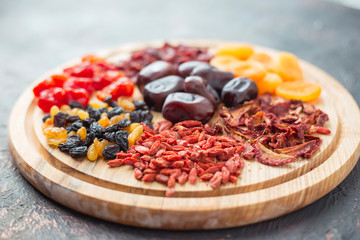 Different dried fruits on a wooden board.