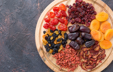Different dried fruits on a wooden board.