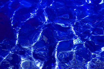 Background made of clean blue water sea surface. Mediterranian surface on sunny day with waves and flares. Copy space.