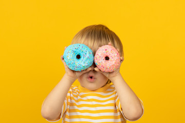 Happy child holding glazed donut