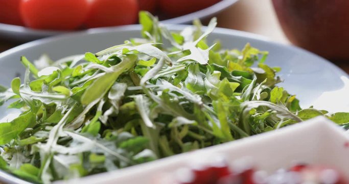 Fresh arugula leaves on plate, close-up