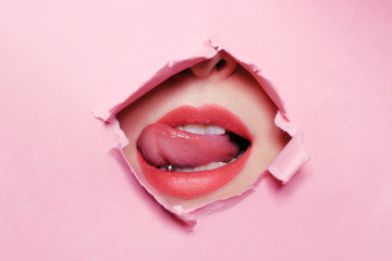 Girl bites her tongue, tongue piercing. Big beautiful lips, piercing parlor. Beautiful teeth,...