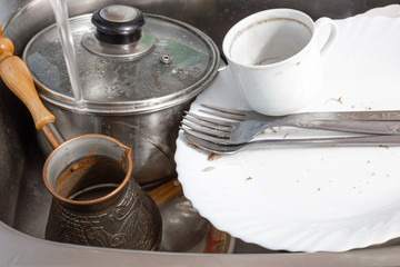 dirty dishes lie in the sink