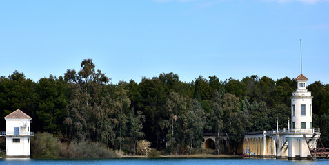 Fototapeta na wymiar Control towers over the Cubillas reservoir in Granada with trees between them