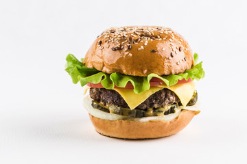 Classic Burger with beef Patty, fresh lettuce, onions, pickles, cheddar cheese and tomatoes.