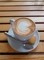 hot Italian cappuccino coffee cup on wooden table background