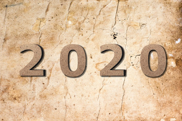 abstract background with the date 2020 on texture of old faded burnt paper, the beginning of a new year, calendar cover design