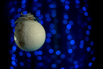 homemade vintage Christmas ball rolling in the air near NewYears Tree. 