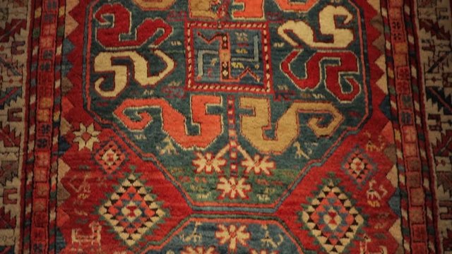 Large oriental rug with colorful patterns. Handmade rug production, carpet close-up with all the details