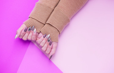 Beautiful stylish female manicure on a pink background.