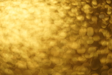 Golden shiny background, gold sparkles blurred background.