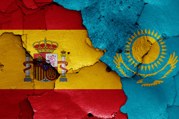 flags of Spain and Kazakhstan painted on cracked wall