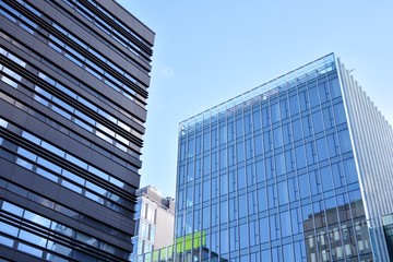 Fototapeta premium Abstract texture of blue glass modern building skyscrapers. Business background.