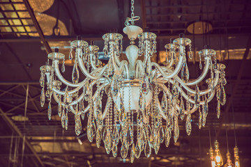 The lamp in the beautiful room .Brass chandelier with crystal. Chandelier ceiling lights . Chandelier Lamp beautiful luxury expensive chandelier hanging under ceiling .