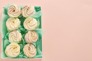Homemade zephyr or marshmallows in a box on a pink background, horizontal orientation, Top view