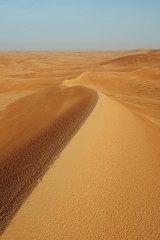 Long range of desert sand dunes in Al Dahna desert near Riyadh in Saudi Arabia after a light rain....