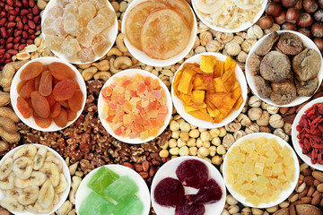Dried fruit & nut collection forming an abstract background. Health food high in antioxidants, protein, omega 3. minerals, vitamins & anthocyanins. Flat lay., top view.