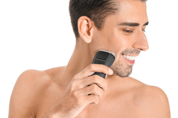 Handsome young man shaving on white background