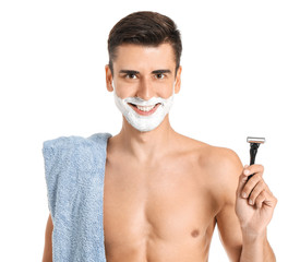 Handsome young man with razor on white background