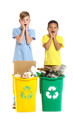 Shocked little boys and containers with trash on white background. Concept of recycling