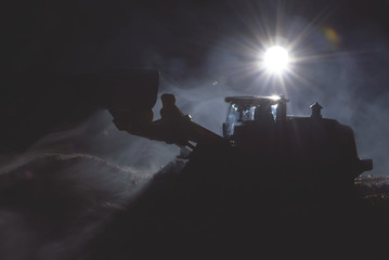 Tractor is working on the construction site at night concept.