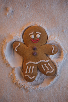 Happy New Year: ginger little man lies on the ground and with the help of his hands and feet makes the shape of an angel leaving a footprint in the snow