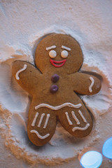 Happy New Year: ginger little man lies on the ground and with the help of his hands and feet makes the shape of an angel leaving a footprint in the snow