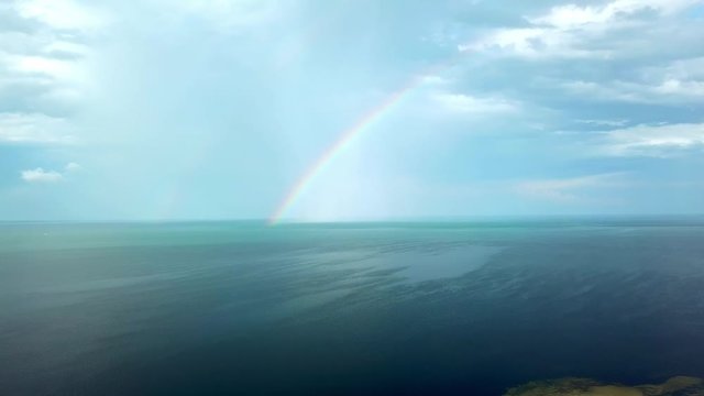 aerial view of rainbow over the sea, aerial view of Rainbow above the sea and island, aerial view of Dzharylgach island with raindbow,  aerial view of lakes on the island and rainbow