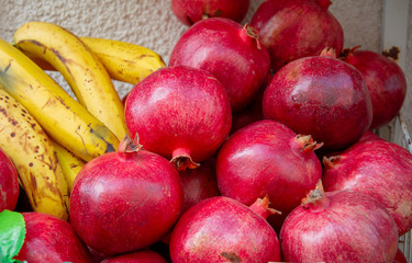 Close up of bananas and pomegranates