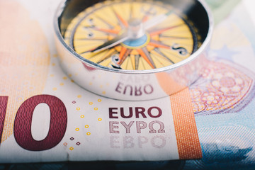 Compass and Euro banknotes as business, currency finance  concept