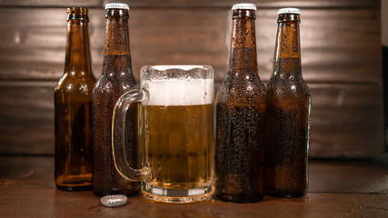Pint Of Beer With four Bottles Behind