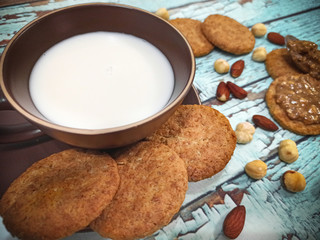 Vegan breakfast with almond milk, peanut butter, hazelnuts and whole grain cookies
