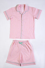 Baby pajamas. Sleeping outfit for baby girl. Pajamas in pink and white colors, square pattern. On white background