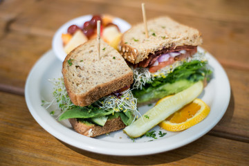 Vegan sandwich on a plate and fruits