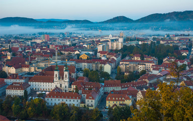Fototapeta na wymiar Cityscape of Graz from Shlossberg hill, Graz, Styria region, Austria, in autumn, at sunrise
